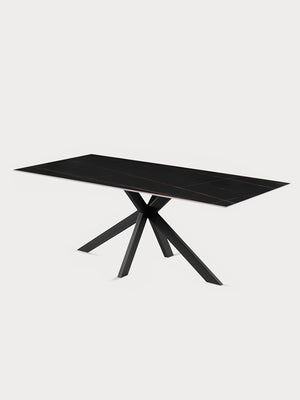 Mesa comedor rectangular con tablero de cerámica veteado negro y patas metálicas en vista lateral.